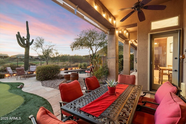 view of patio terrace at dusk