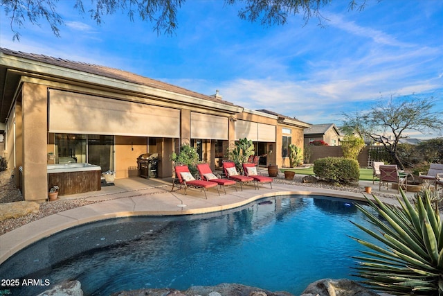 view of pool with a grill and a patio area