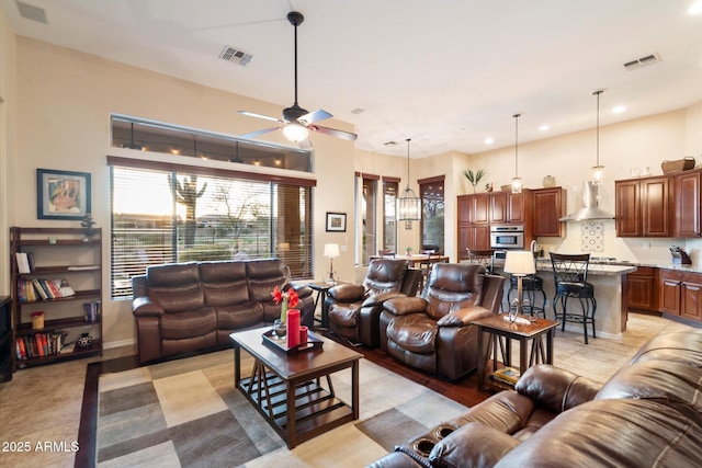 tiled living room featuring ceiling fan