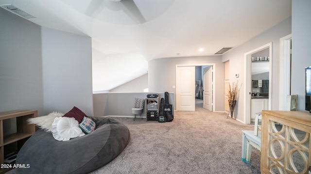 living area featuring light carpet, ceiling fan, and vaulted ceiling