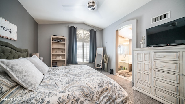 carpeted bedroom with connected bathroom, vaulted ceiling, and ceiling fan