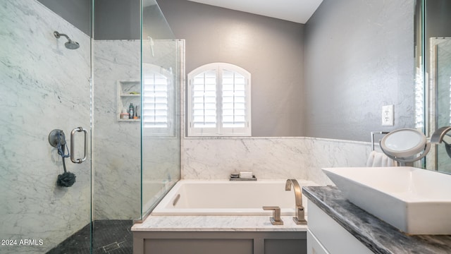 bathroom with vanity, separate shower and tub, and vaulted ceiling