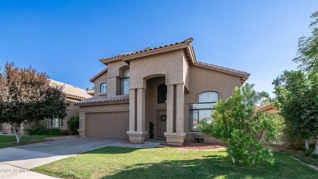 mediterranean / spanish-style house with a front lawn and a garage