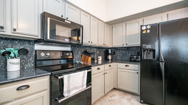 kitchen with light tile patterned floors, tasteful backsplash, dark stone countertops, and black appliances