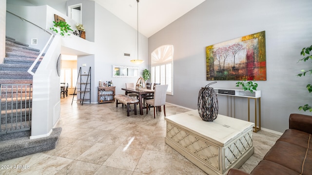 living room featuring high vaulted ceiling