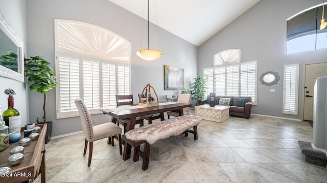 dining area with high vaulted ceiling and a wealth of natural light