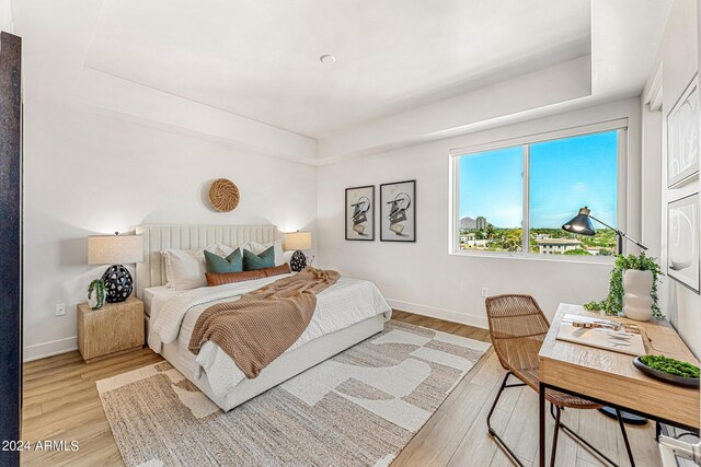 3131 N Central Ave Unit 6017, Phoenix, AZ 85012 - bedroom with light wood finished floors and a raised ceiling