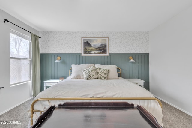 bedroom featuring a wainscoted wall, carpet flooring, and wallpapered walls