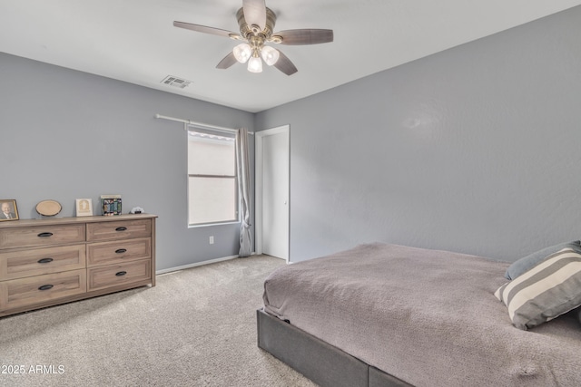 bedroom featuring visible vents, a ceiling fan, and light colored carpet