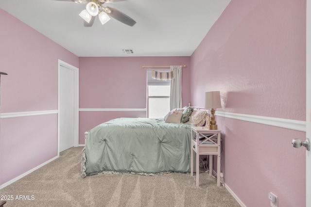 bedroom with carpet floors, ceiling fan, visible vents, and baseboards