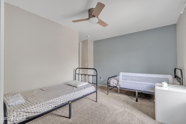 bedroom featuring a ceiling fan and carpet