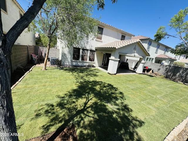 3533 E Harwell Rd, Gilbert, AZ 85234 - back of property featuring a fenced backyard, stucco siding, a lawn, and a tiled roof