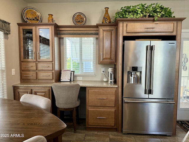 kitchen featuring tile patterned floors, light stone countertops, and high end fridge