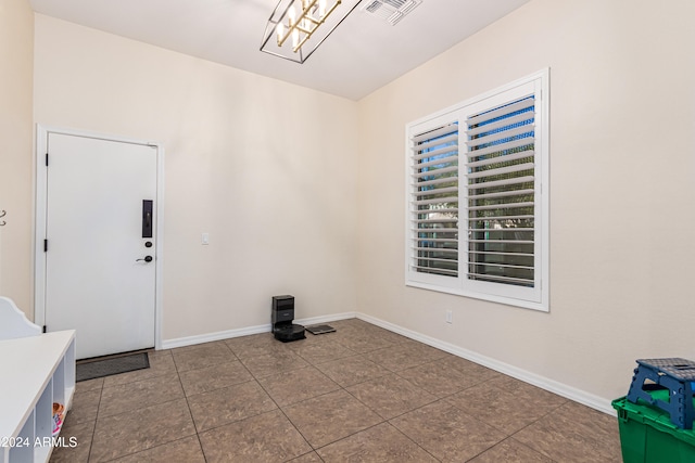 clothes washing area with tile patterned floors