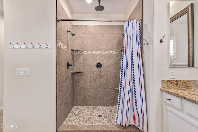 bathroom with curtained shower and vanity