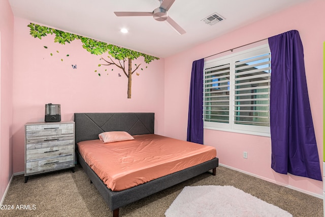 bedroom featuring multiple windows, ceiling fan, and dark colored carpet