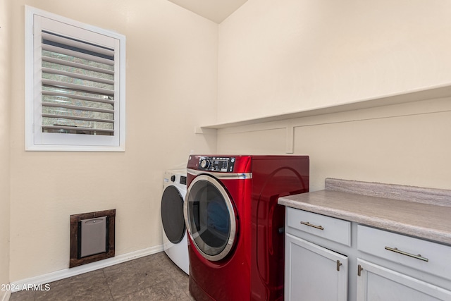 laundry room with cabinets and washer and clothes dryer