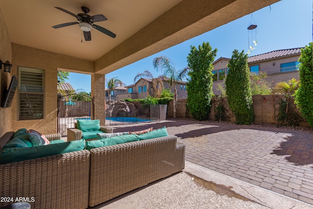 view of patio with a swimming pool, ceiling fan, and an outdoor hangout area