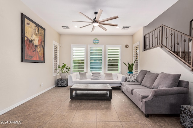 living room featuring light tile patterned floors and ceiling fan