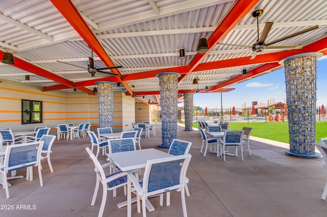 view of patio / terrace with fence, outdoor dining area, and a ceiling fan