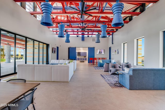 living room featuring a towering ceiling