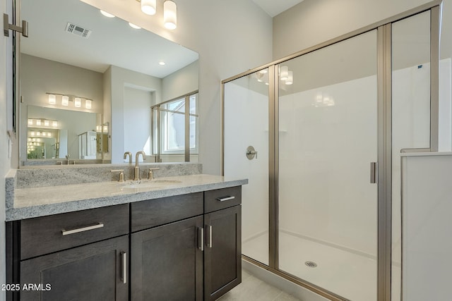 bathroom featuring tile patterned flooring, walk in shower, and vanity