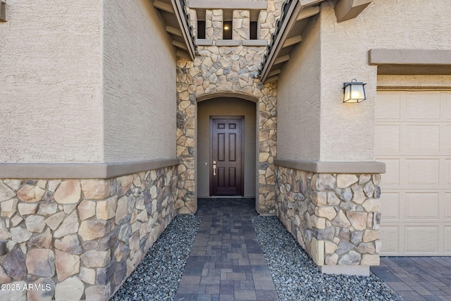 view of exterior entry featuring a garage