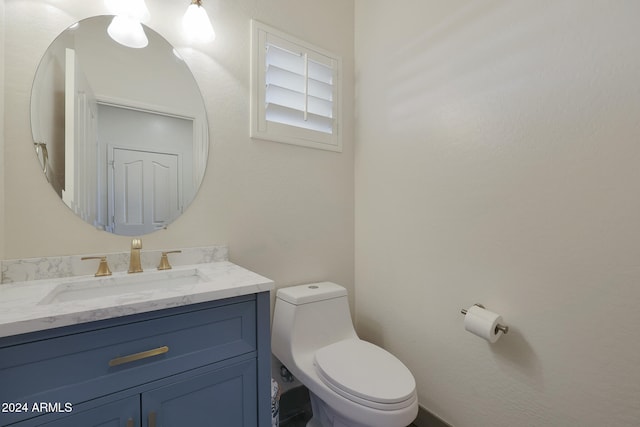 bathroom featuring toilet and vanity