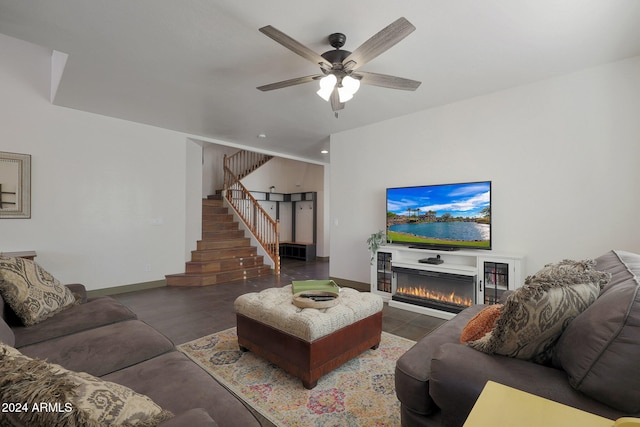 living room featuring dark wood-type flooring and ceiling fan