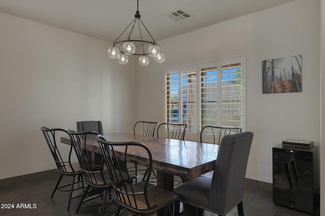 tiled dining room featuring a chandelier