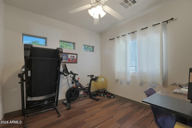 workout area featuring dark wood-type flooring and ceiling fan