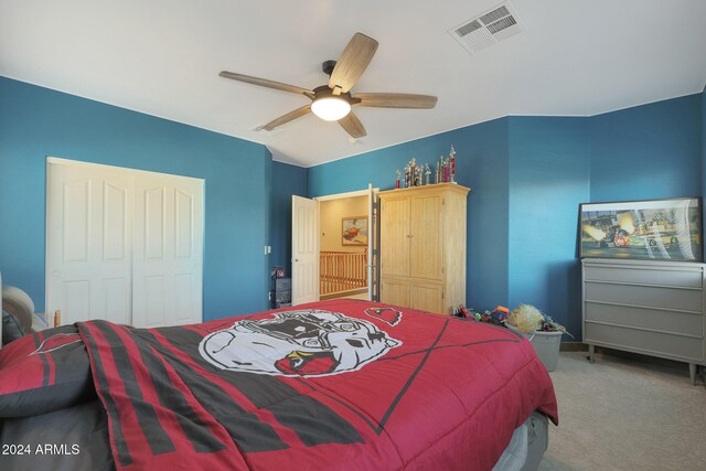 bedroom featuring a closet, ceiling fan, and light colored carpet