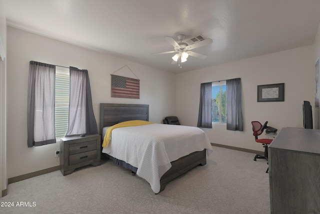 bedroom with light colored carpet and ceiling fan