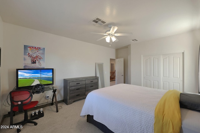 carpeted bedroom featuring a closet and ceiling fan