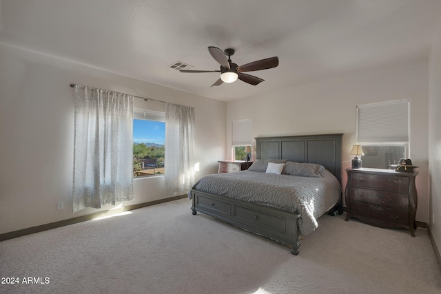 bedroom with light carpet and ceiling fan