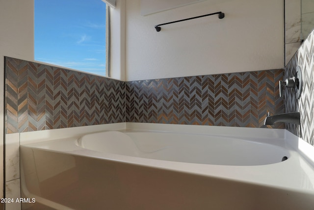 bathroom featuring tile walls and a tub