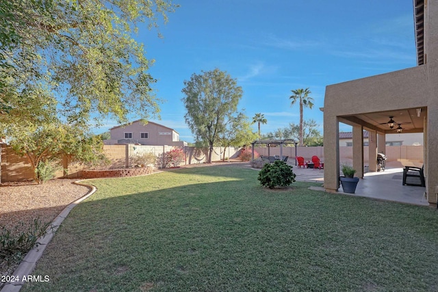 view of yard with a patio area and ceiling fan