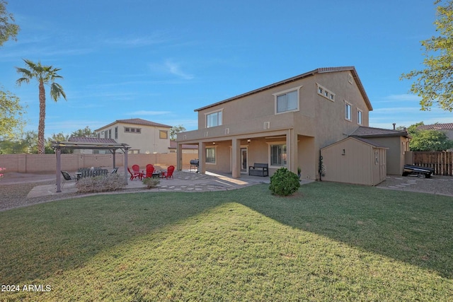 rear view of property with a patio, a pergola, and a yard