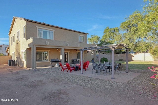 rear view of house with a pergola, a patio area, and central AC unit