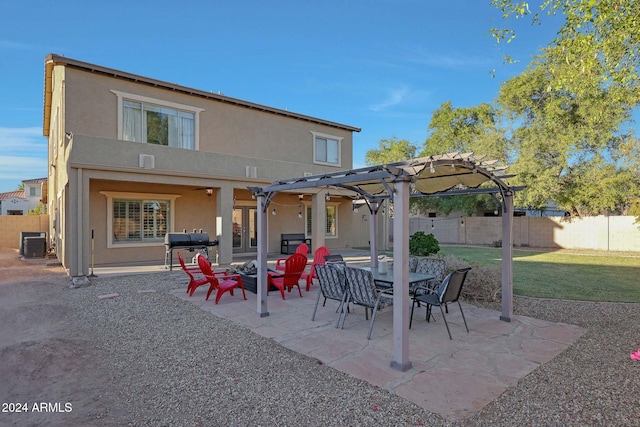 rear view of house featuring central AC, a patio, a lawn, and a pergola