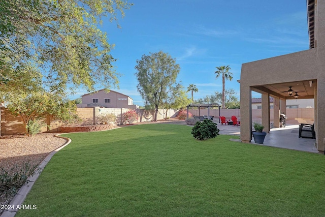 view of yard with a patio area, a playground, and ceiling fan