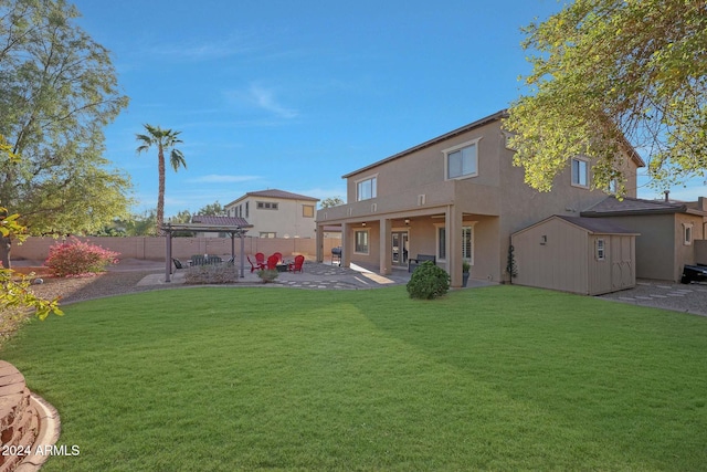 back of house featuring a patio area and a lawn