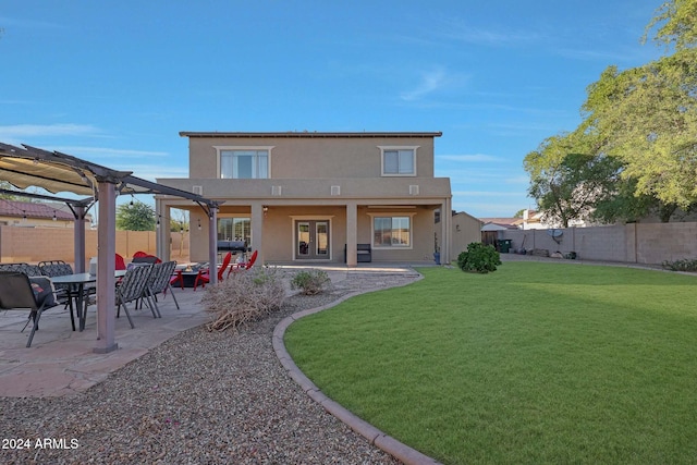 back of house featuring a patio, a yard, and a pergola