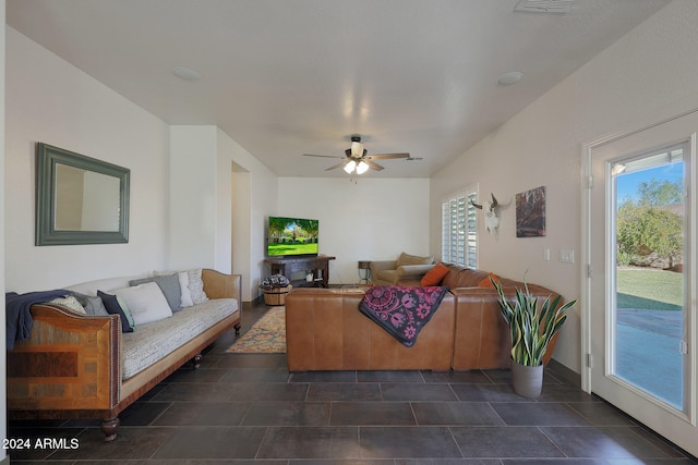 tiled living room with ceiling fan and plenty of natural light