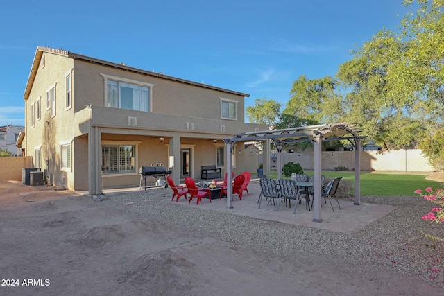 rear view of property with a patio area, a yard, cooling unit, and a pergola