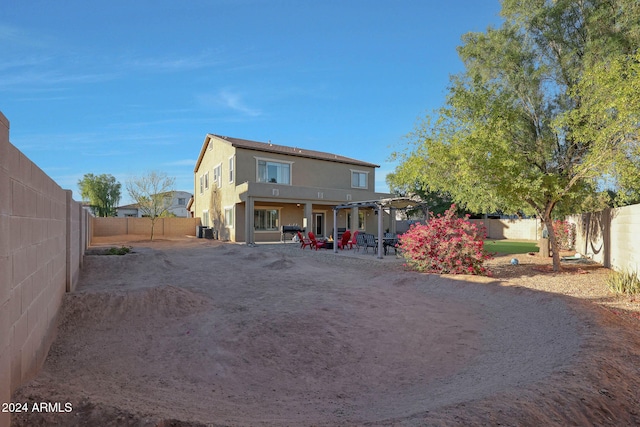 rear view of property with central AC