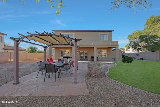 back of property featuring a pergola, a patio, and a yard