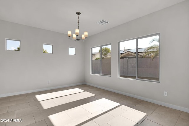 unfurnished room featuring light tile patterned floors and an inviting chandelier