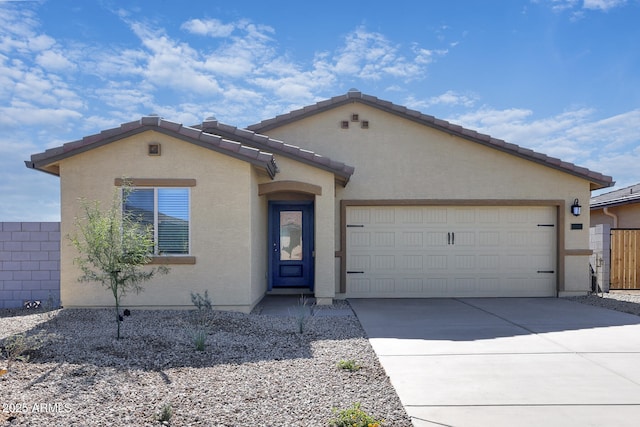 24593 W St Catherine Ave, Buckeye, AZ 85326 - view of front of house with a tiled roof, an attached garage, concrete driveway, and stucco siding