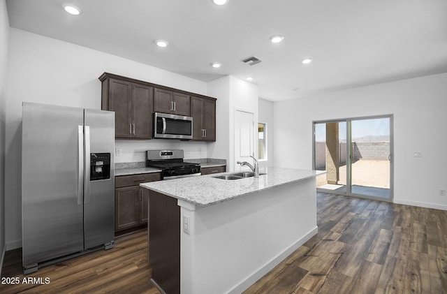 24593 W St Catherine Ave, Buckeye, AZ 85326 - kitchen featuring dark brown cabinets, appliances with stainless steel finishes, a sink, dark wood-type flooring, and visible vents
